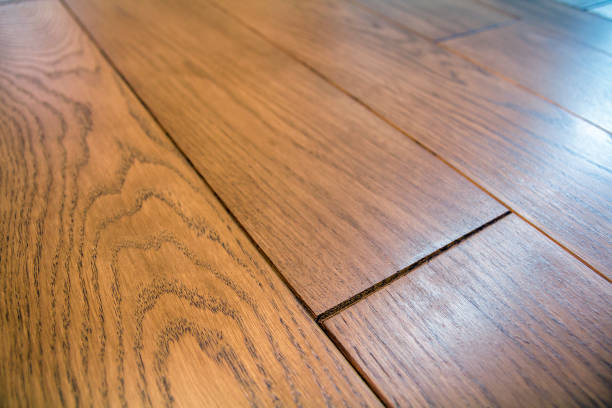 istock Natural light brown wooden parquet floor boards. Sunny soft yellow texture, copy space perspective background. 1129659407