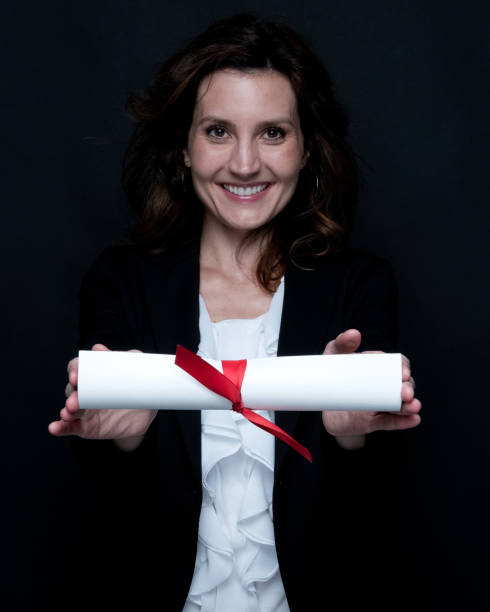 istock Businesswoman is holding a diploma 1129659892
