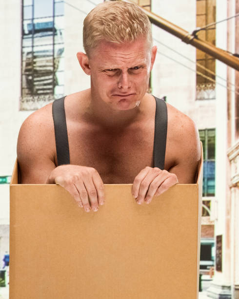 istock Poverty man in box shirtless is crying 1129663198