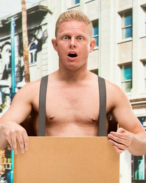 istock Poverty man in box shirtless is shocked 1129663495