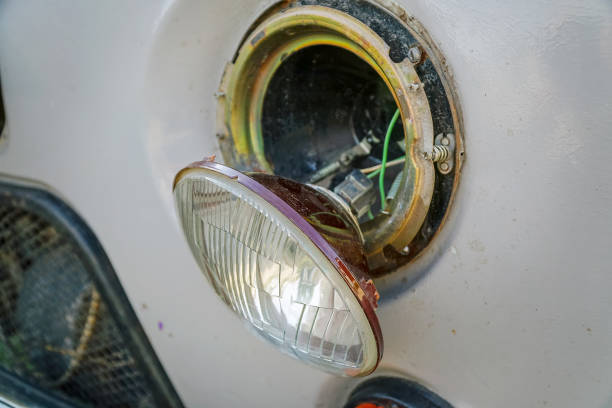 istock Broken car headlight hanging on the wires 1129663706