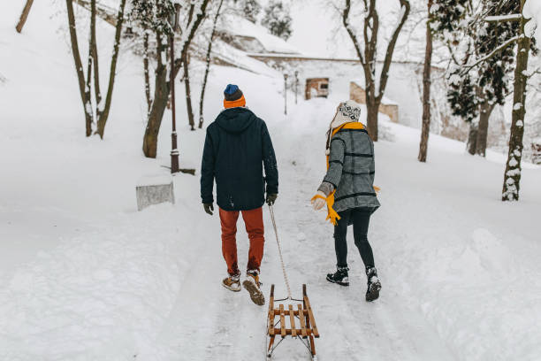 istock Couple in the snow sledding 1129664830