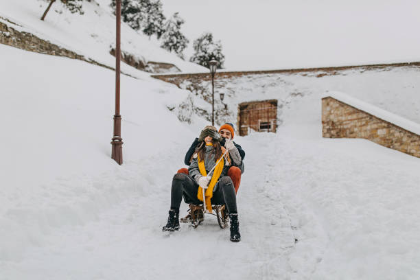 istock Couple in the snow play with dog 1129664952