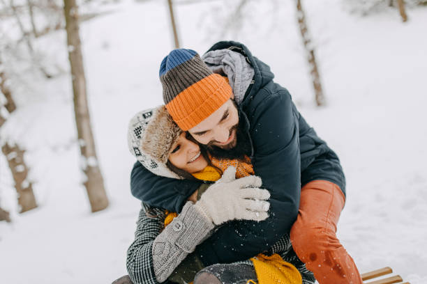 istock Couple in the snow sledding 1129665175