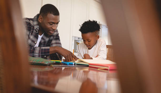istock African American father helping his son with homework at table 1129666129