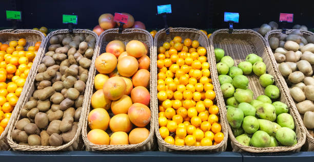 istock Assorted tropical fruit baskets in a grocery store. Sale shop 1129667623