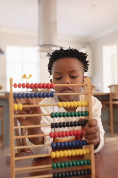 istock African American boy learning mathematics with abacus at table 1129667972