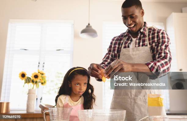 African American Father And Daughter Baking Cookies In Kitchen Stock Photo - Download Image Now