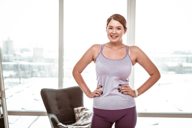 istock Smiling resolute young woman wearing comfortable light clothes 1129671259