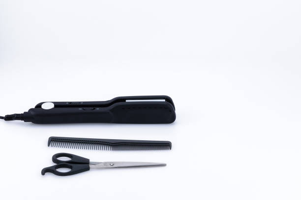 istock Grey hair iron with accessory on the white background with copy space. 1129672053