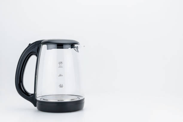 istock Glass transparent kettle on the white background with copy space 1129672085