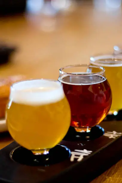 Beer Flight. A sample of various types of beer in glass containers.