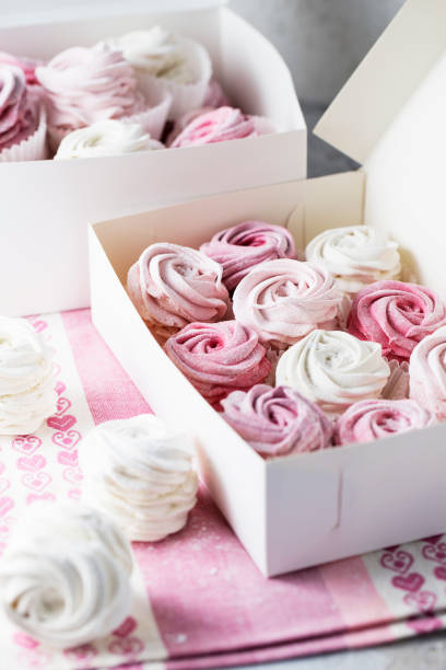 istock Sweet dessert zephyr marshmallows close up. Big zephyr sprinkled with powdered sugar. Valentine's Day concept 1129673855