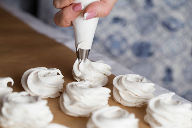 istock The process of making marshmallow. Sweet dessert white zephyr marshmallows close up. 1129673946