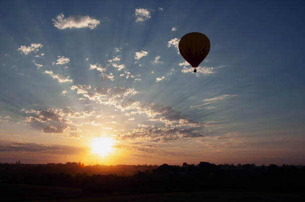 istock A hot air balloon is silhouetted against a sunset 1129675265
