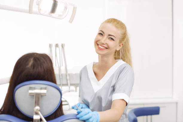istock Dentist young female standing in her office and looking at camera. 1129675369
