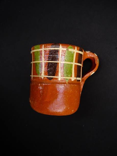 istock Artisanal Clay Cup, handcrafted earthware from Jalisco Mexico, Isolated on a black background 1129675388
