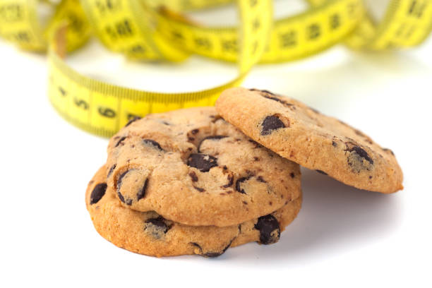 istock Chocolate Chip Cookie  with Measuring Tape Isolated on White, Diet Concept 1129675511