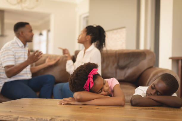 istock African American children leaning on table while parents arguing on the sofa 1129675617