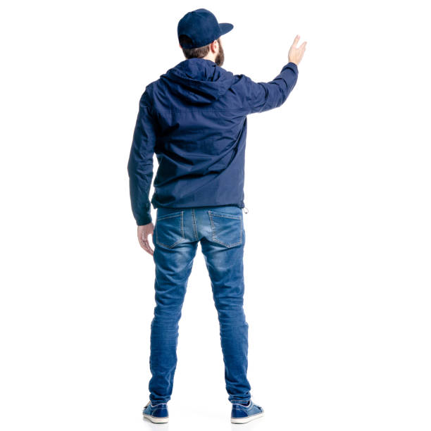 istock A man in jeans and jacket standing looking showing pointing 1129675800