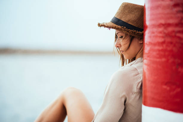 istock Girl by the sea 1129676377