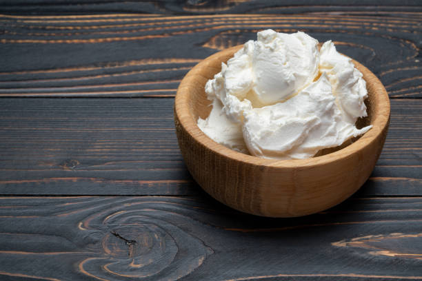 traditionelle mascarpone käse in holzschale auf tisch - schmierkäse stock-fotos und bilder