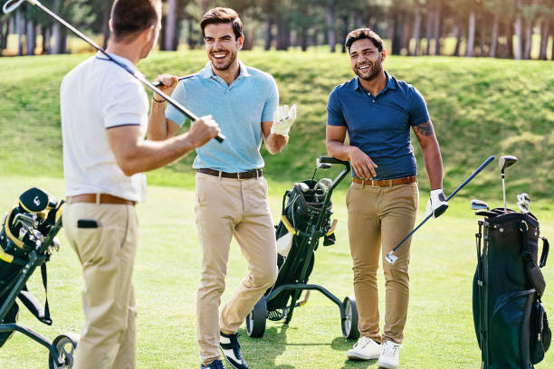 istock Group of men playing golf on a sunny day 1129676857