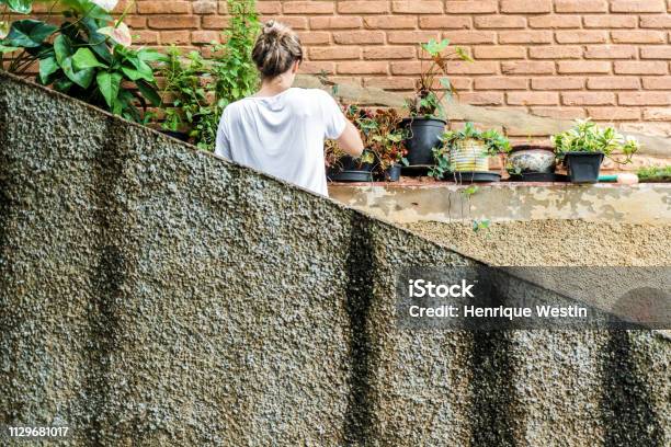 Young Blond Woman In Her 30s Taking Care Of The Garden Stock Photo - Download Image Now