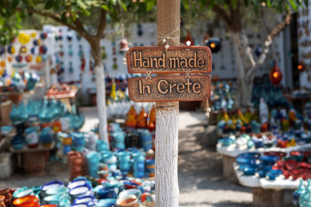 Handmade in Crete sign on a board attached to a pole. Chania, Crete - August 2018: Handmade in Crete sign on a board attached to a pole. herakleion photos stock pictures, royalty-free photos & images