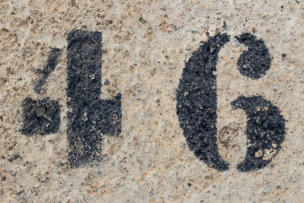 number forty six painted stencil on concrete wall