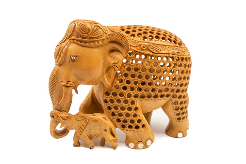 Traditional carved elephant mother and baby figurine souvenir, isolated on a white background