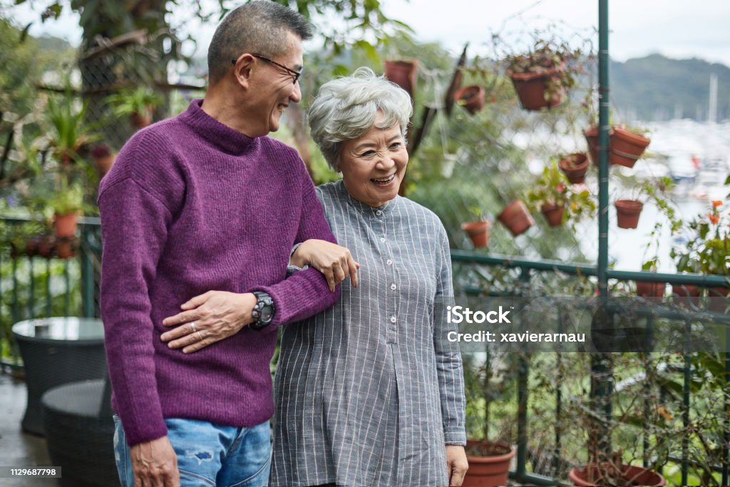 Happy affectionate senior couple walking together Happy elderly couple talking while holding hands. Senior man and woman are enjoying retirement years. They are walking together at restaurant. Senior Adult Stock Photo