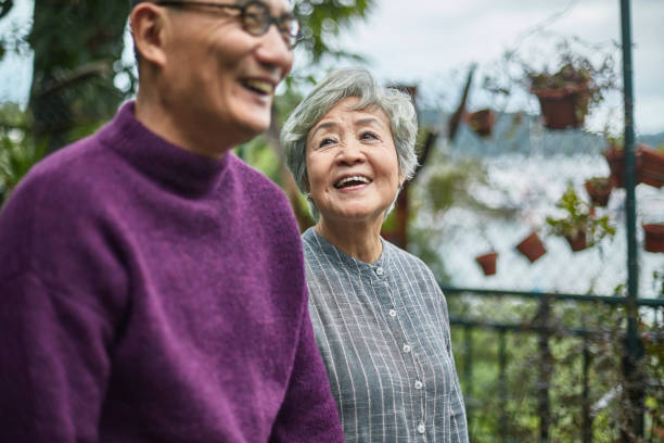 smiling senior woman looking at man in restaurant - couple walking old middle imagens e fotografias de stock