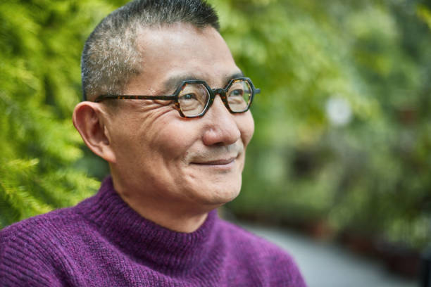 istock Close-up of thoughtful smiling man looking away 1129688189