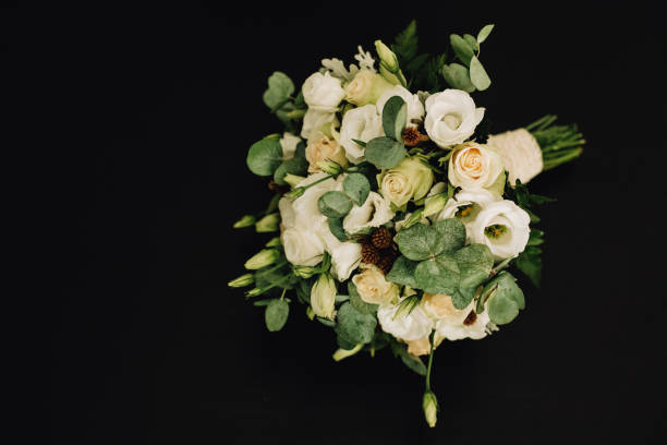 istock Bouquet of white roses on a black isolated background 1129691981