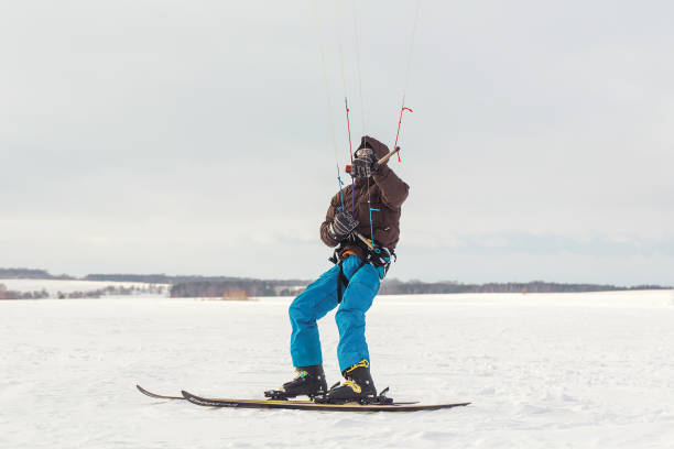 istock The skier goes on the snow field with kite 1129692911