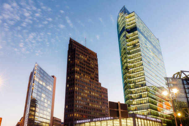 istock Illuminated high-rise architecture at Potsdamer Platz Bahnhof in Berlin at night 1129693044