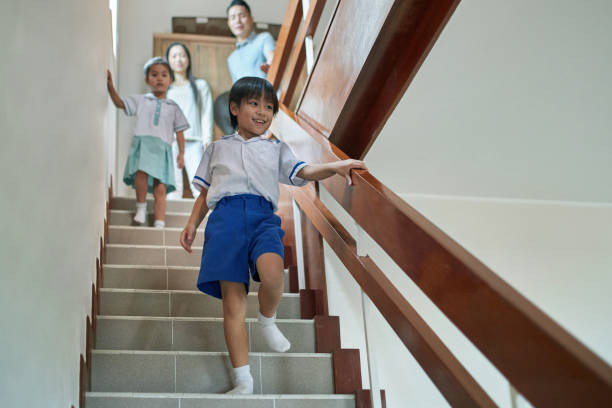 istock Smiling boy with family on steps at home 1129693082
