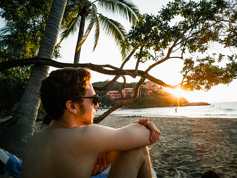 One young man only, beach, tourist resort, sunset, pacific ocean,