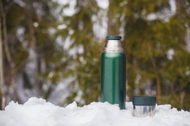 istock Tea from a thermos in the winter cold forest 1129698625