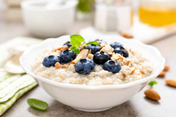 istock Oatmeal with fresh blueberry, almond nuts and honey for breakfast 1129701068