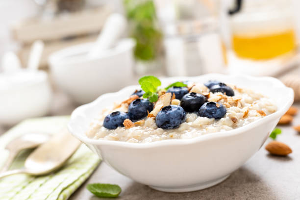 istock Oatmeal with fresh blueberry, almond nuts and honey for breakfast 1129701096