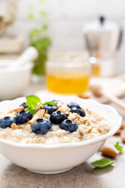 istock Oatmeal with fresh blueberry, almond nuts and honey for breakfast 1129701141