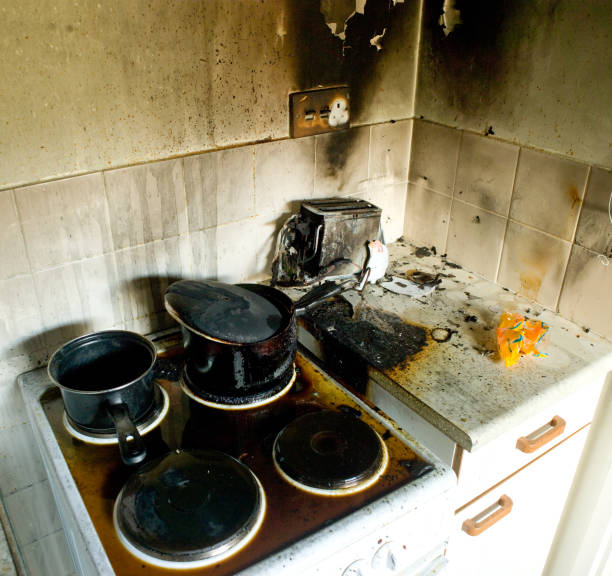 fire damage in kitchen a recent fire in a domestic kitchen showing damage to various appliances kitchen on fire stock pictures, royalty-free photos & images