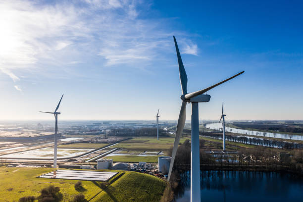 Windmills / wind turbines providing eco friendly renewable energy from sustainable resources. Near Waalwijk, Noord Brabant, Netherlands. Windmills providing energy from wind. berkel stock pictures, royalty-free photos & images