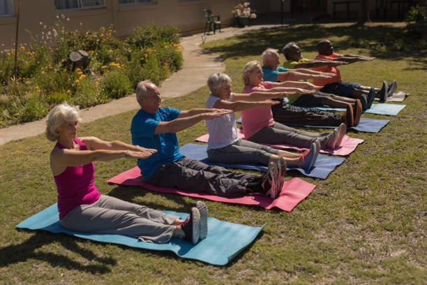 istock Group of senior people exercising in the park 1129705308