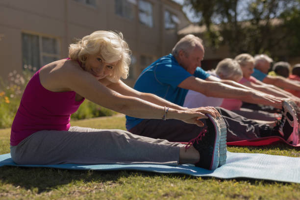 istock Group of senior people exercising in the park 1129705405