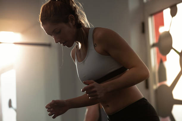 istock Young athletic woman exercising in a gym. 1129711615