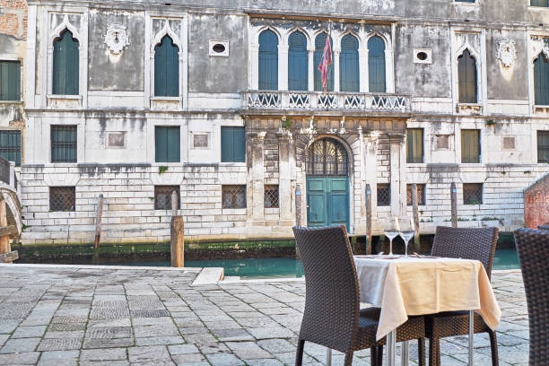 istock Restaurant table near the canal in Venice, Italy. 1129711799