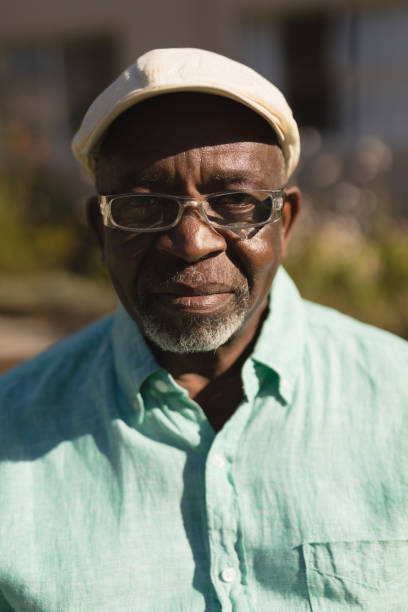 istock Senior man in spectacle smiling in the park 1129711926